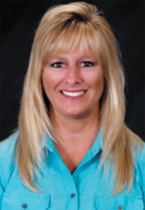 A woman with blonde hair and blue shirt.