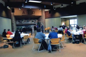 A group of people sitting at tables in a room.